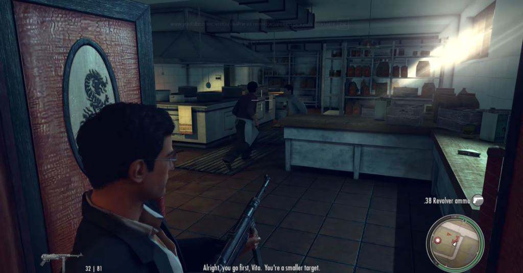 Man with gun in restaurant kitchen.