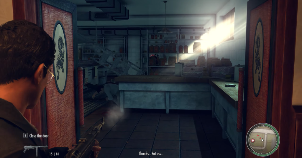 Man aiming gun in restaurant kitchen.