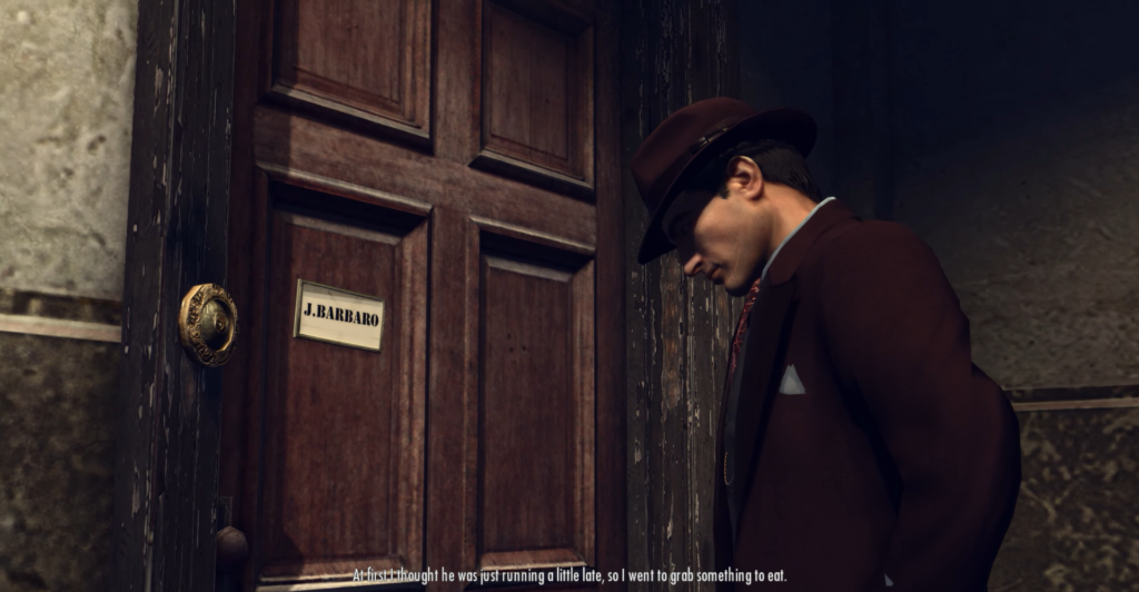 Man in brown suit near door.