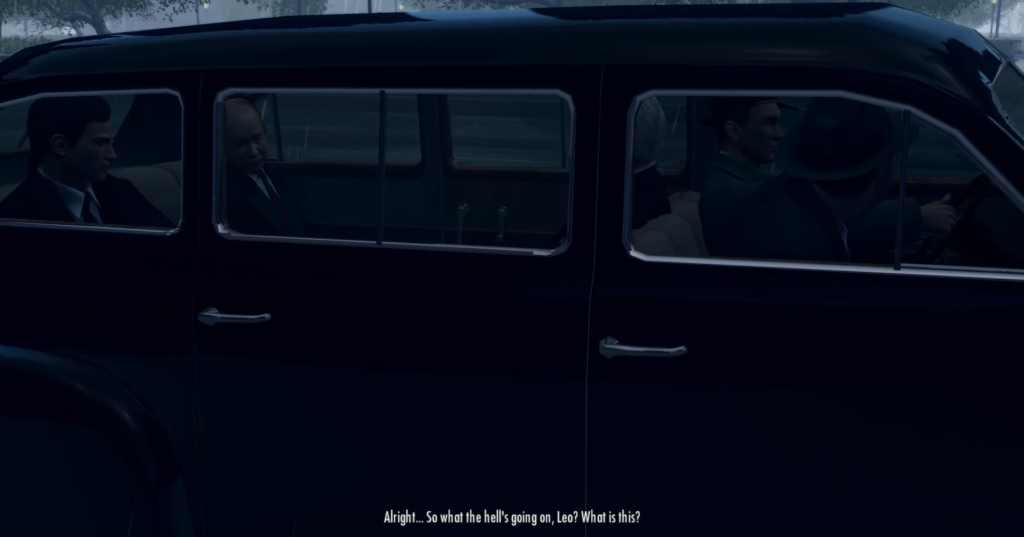 Men in black car discussing situation.