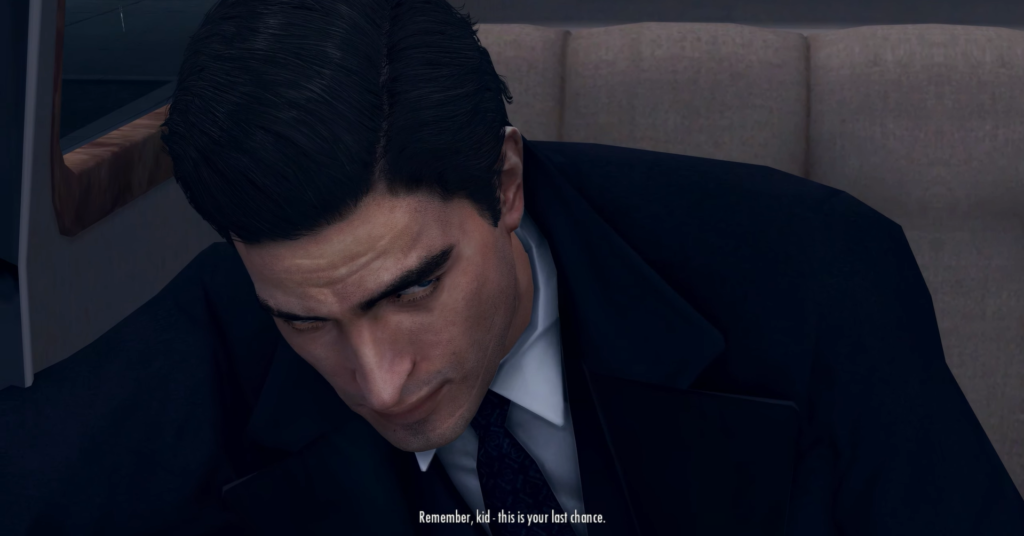 Man in suit, serious expression, speaking.