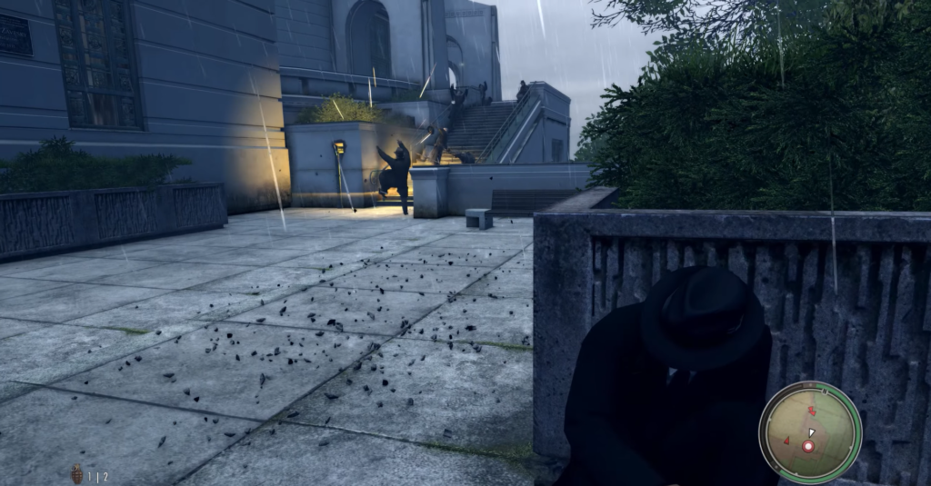 Man in black suit crouching rain.