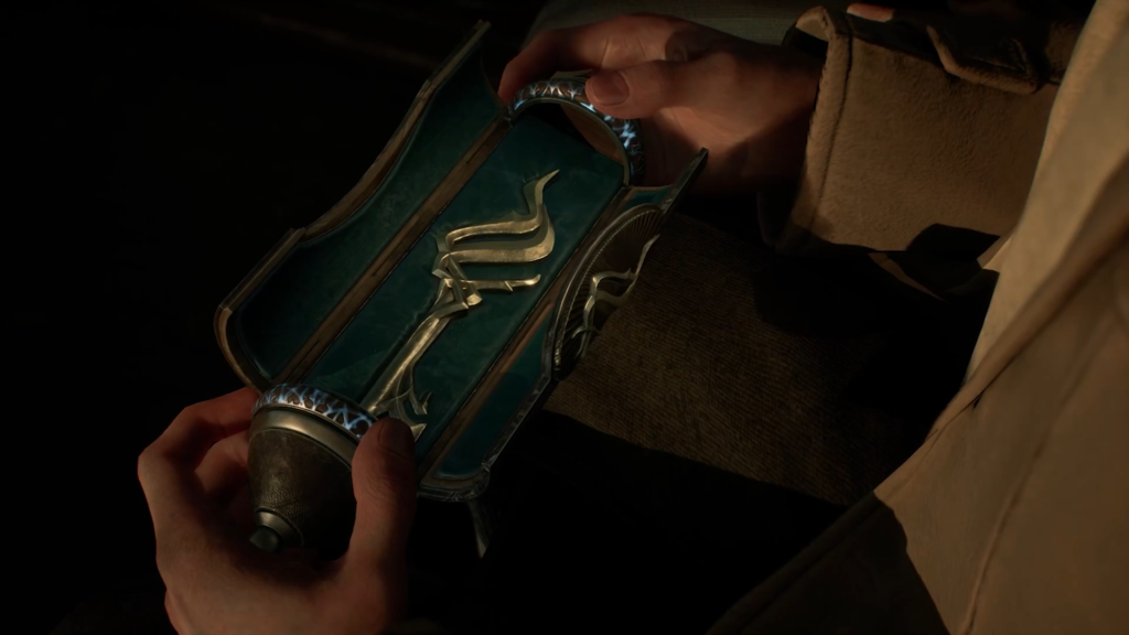 Hands holding blue vial with silver emblem in dark