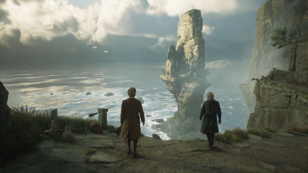 Two people walk toward cliff overlooking ocean rock tower