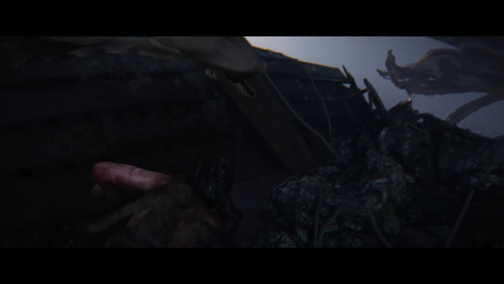 Dragon lying on rocky ground under cloudy sky