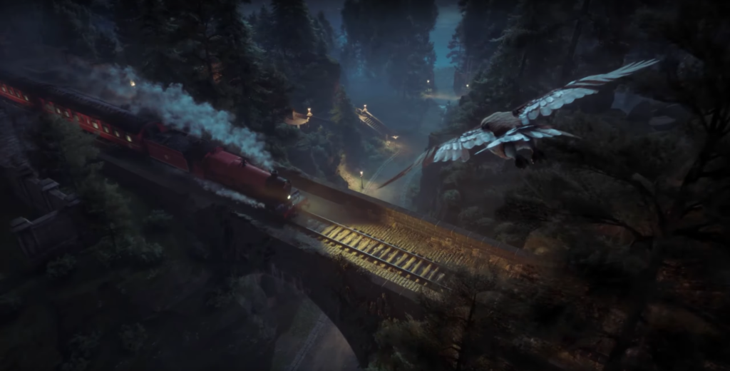 Red steam train crossing bridge over forest valley