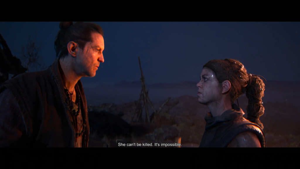 Two people face each other outdoors at night