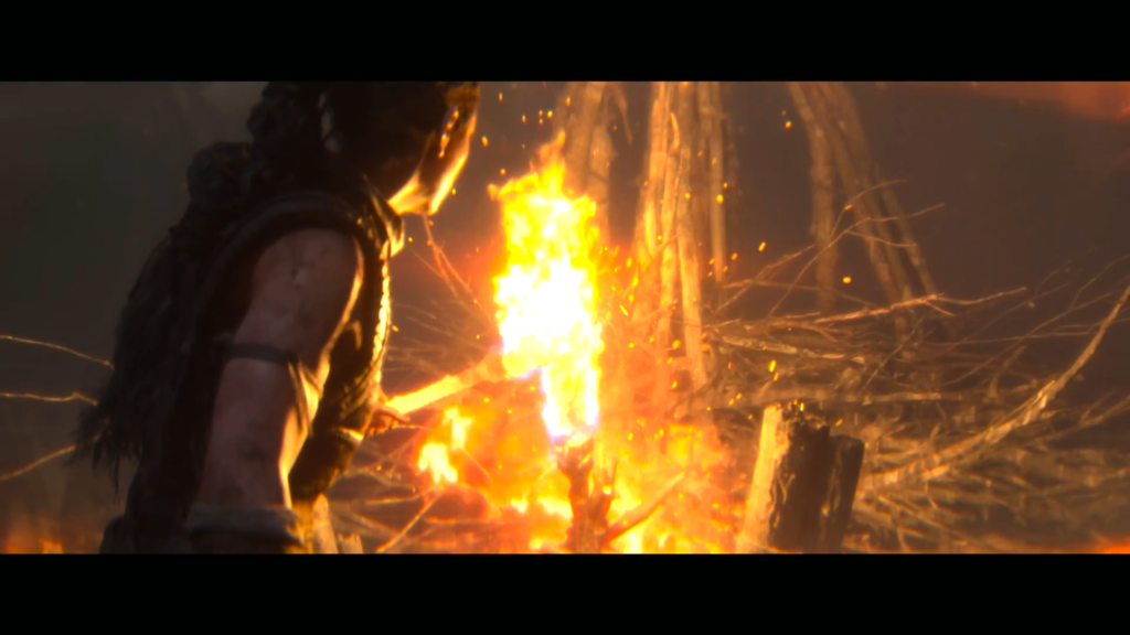 Woman holding flaming torch in dark forest