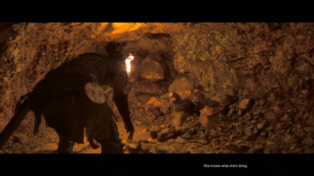 Woman holds torch in rocky cave wall