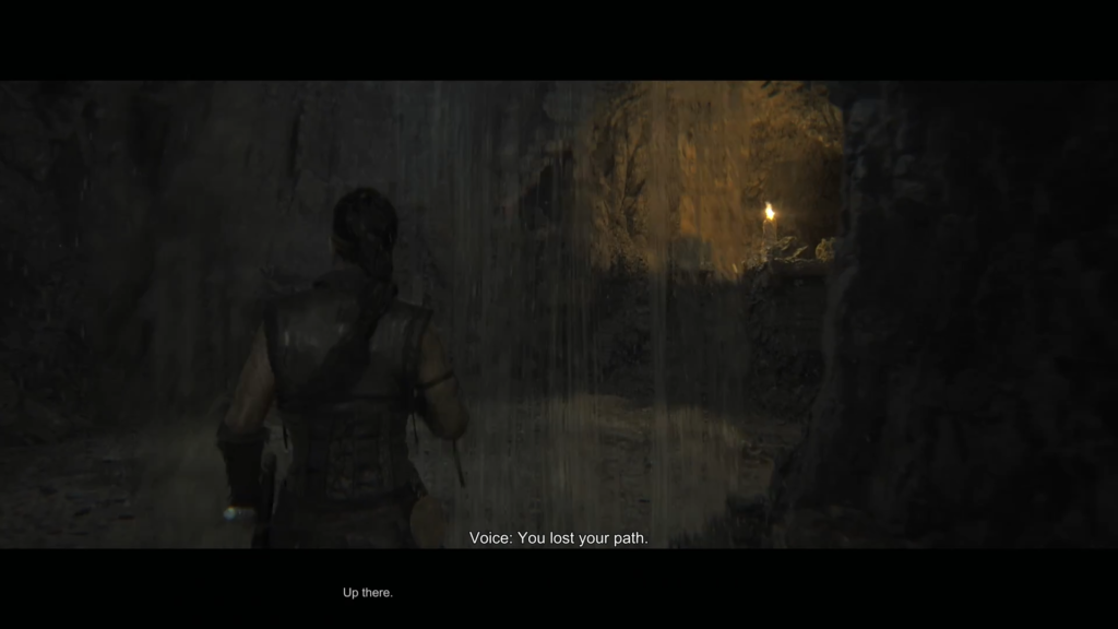 Leon S. Kennedy walks through cave waterfall in Resident Evil 4