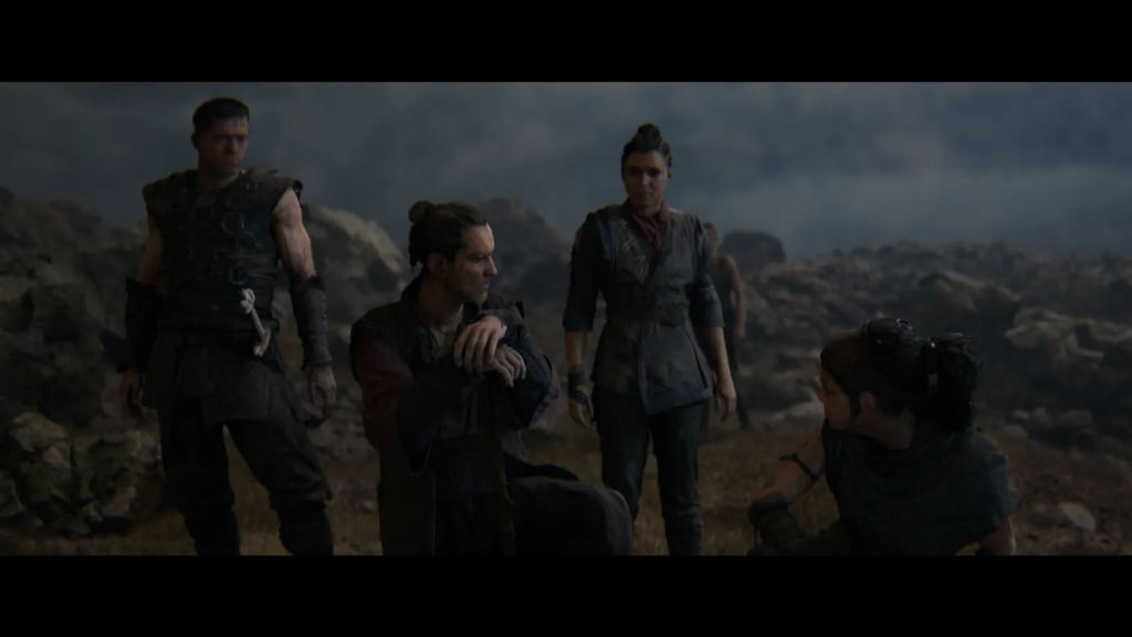 Group of warriors resting on rocky battlefield under cloudy sky