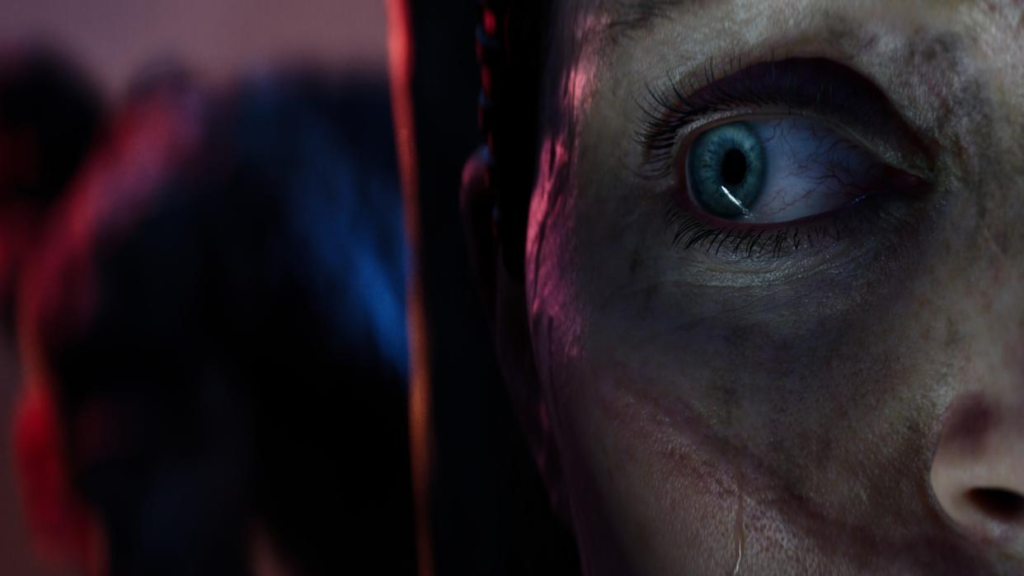 Close-up of blue eye on face in darkness