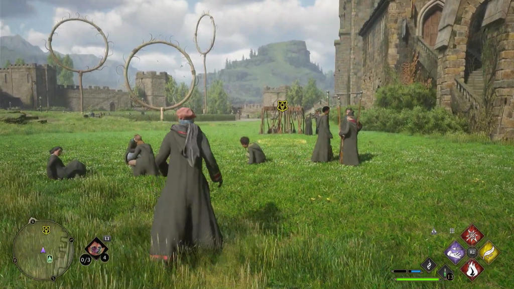 Hogwarts Legacy student walking on grass near Quidditch hoops