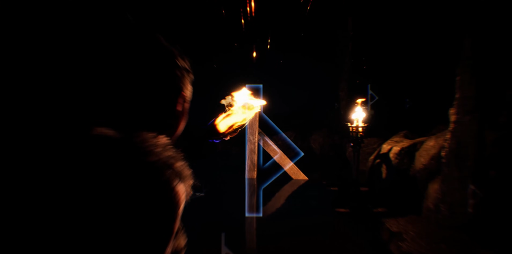 Горящий факел освещает руну в тёмной пещере