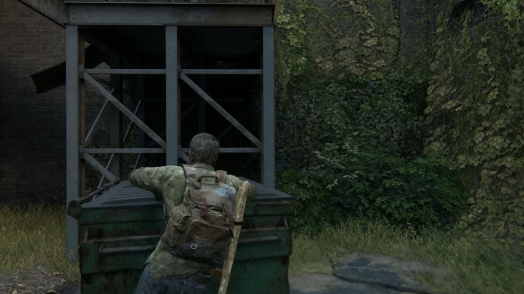 Joel climbs dumpster near ivy-covered building in The Last of Us