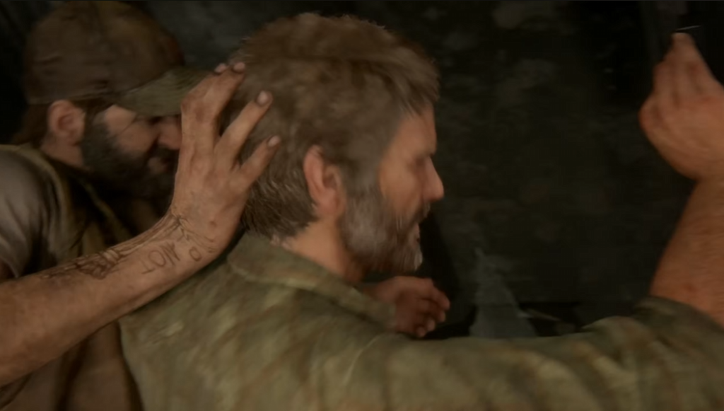 Two men restrain bearded man inside dark room