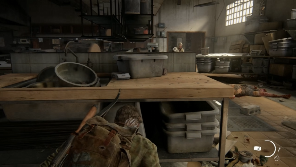 Joel crouches under table in The Last of Us kitchen