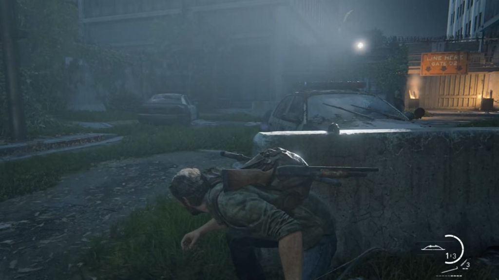 Joel crouches behind concrete barrier in The Last of Us
