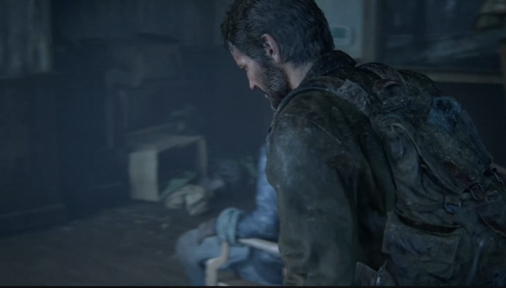 Joel from The Last of Us kneeling indoors