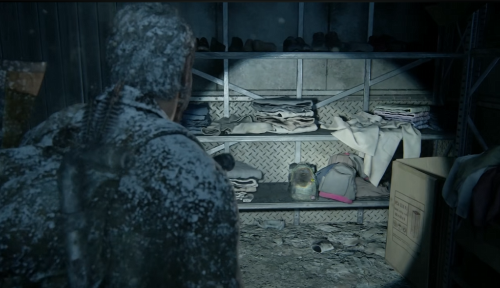 Snow-covered person looking at shelves of folded clothes