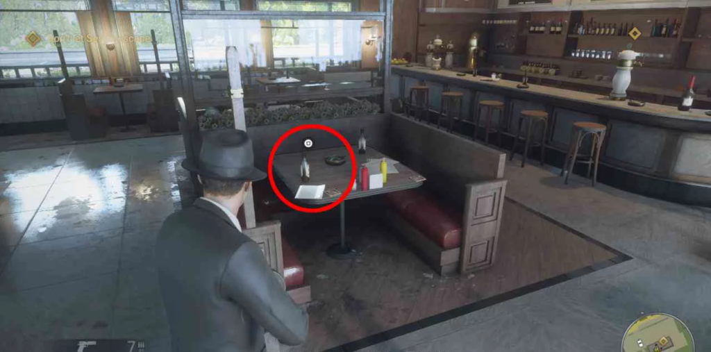 Mafia character aiming gun at diner booth table
