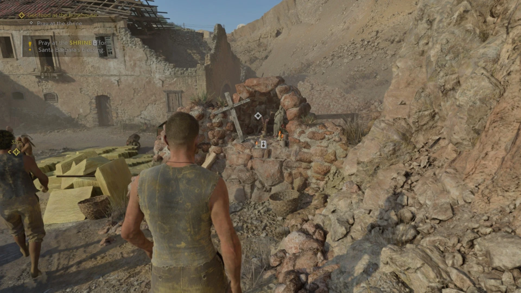 Player approaches stone shrine in desert village ruins