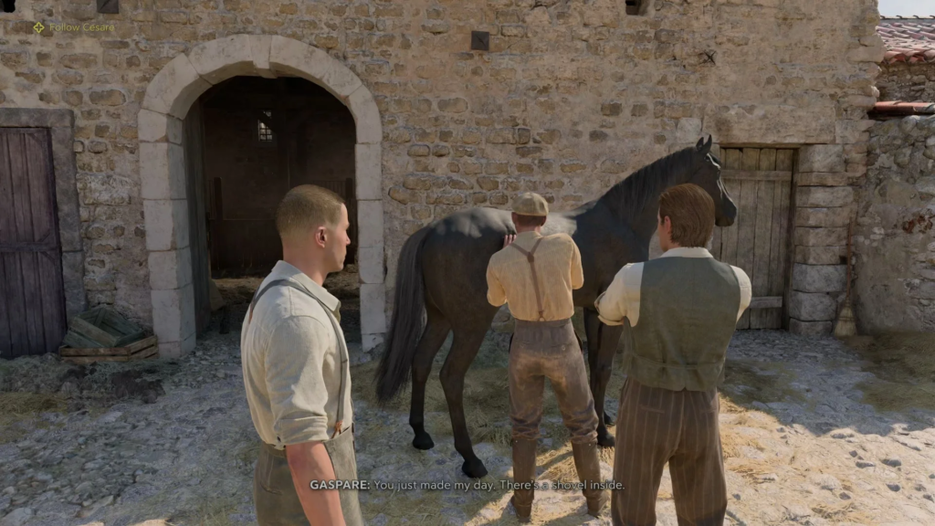 Men grooming black horse outside stone stable courtyard