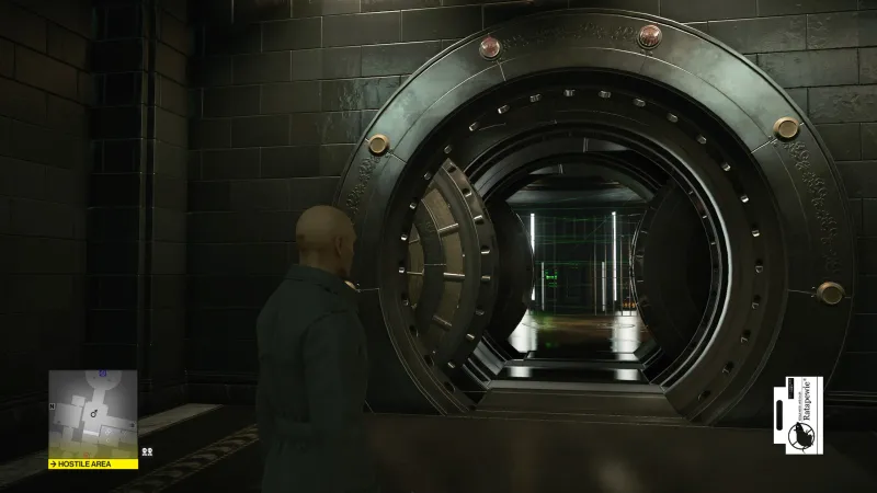 Agent 47 entering vault doorway in Hitman facility
