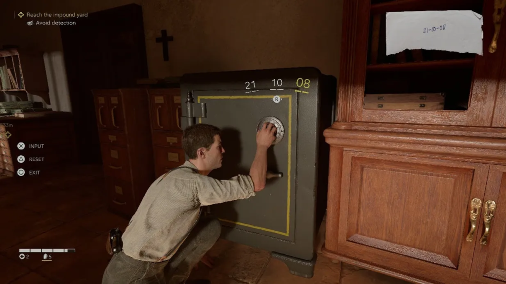 Man kneeling opening safe in office room