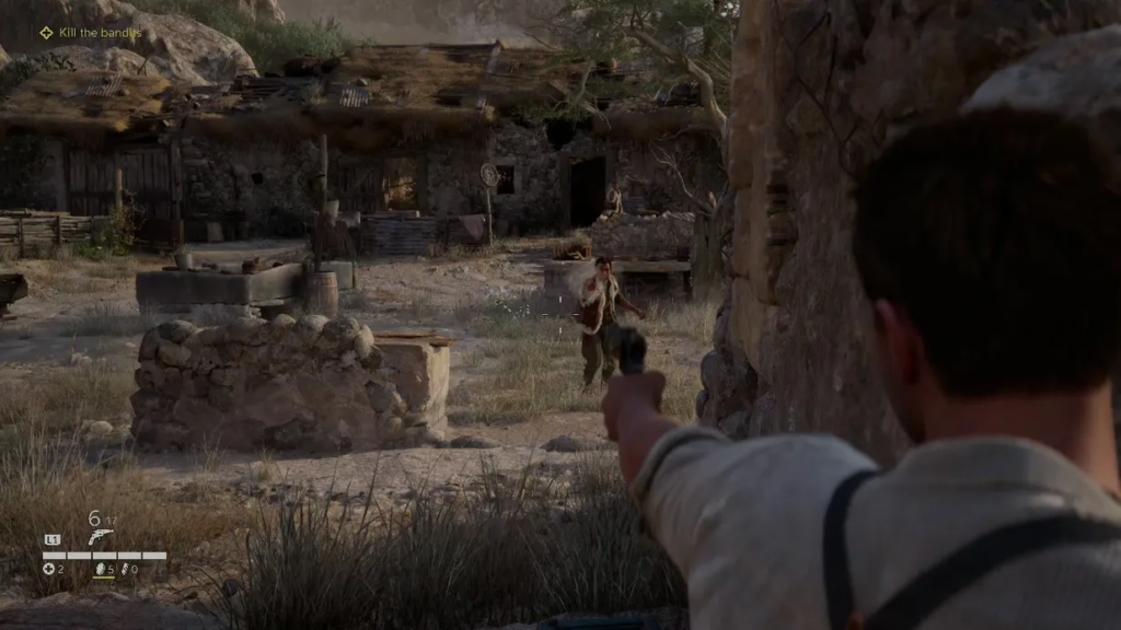 Player aiming pistol at bandit in desert village