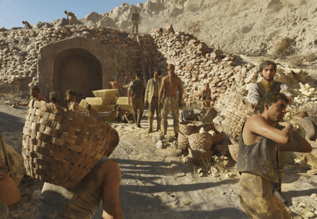 Workers carry baskets near mine entrance in rocky desert