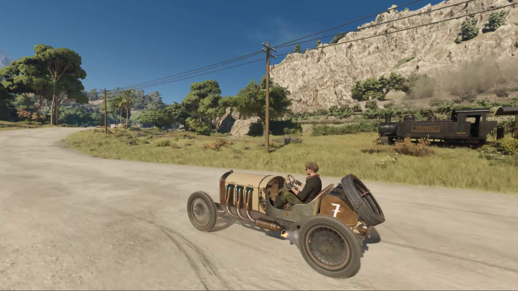 Driver steering vintage race car on dirt road