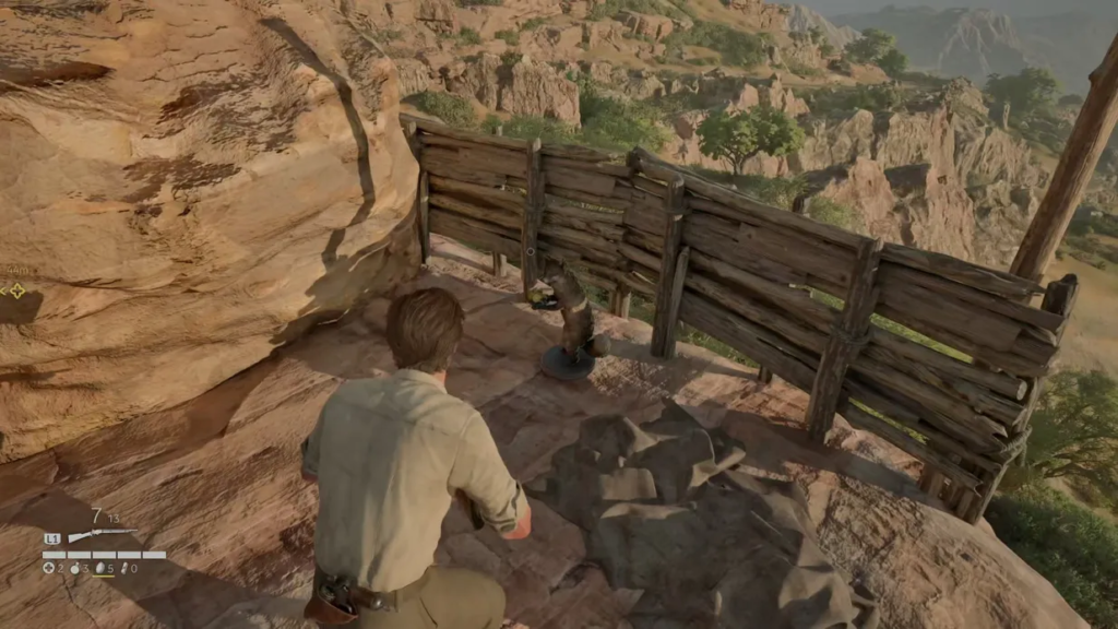 Man aiming rifle at snake on rocky ledge