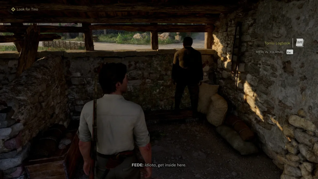 Two men standing inside stone shed in game