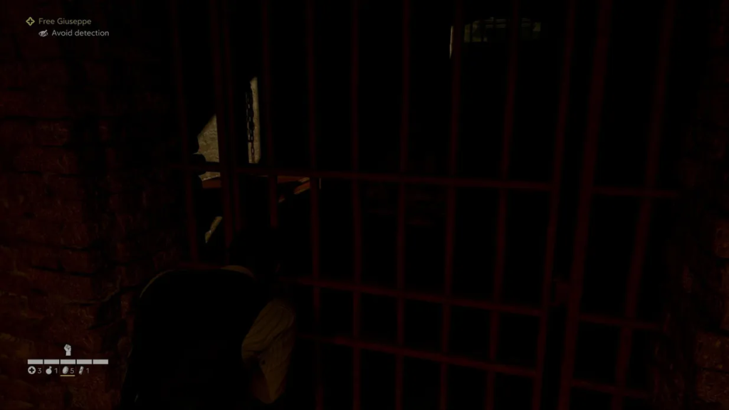 Man crouching behind red bars in dark cell