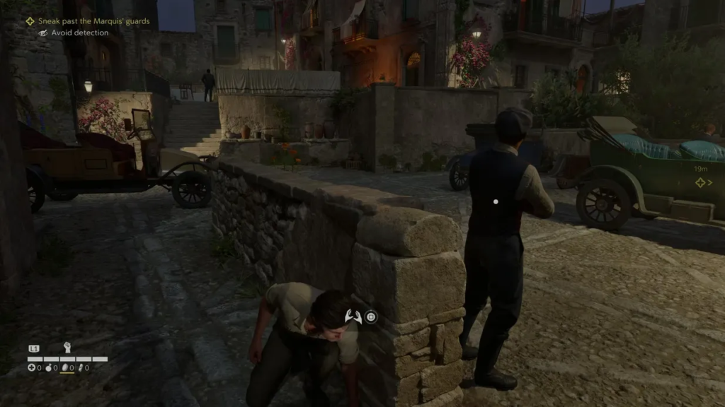 Man crouches behind stone wall in village street