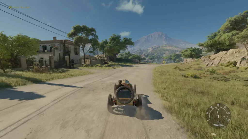 Vintage car driving on rural road toward mountains