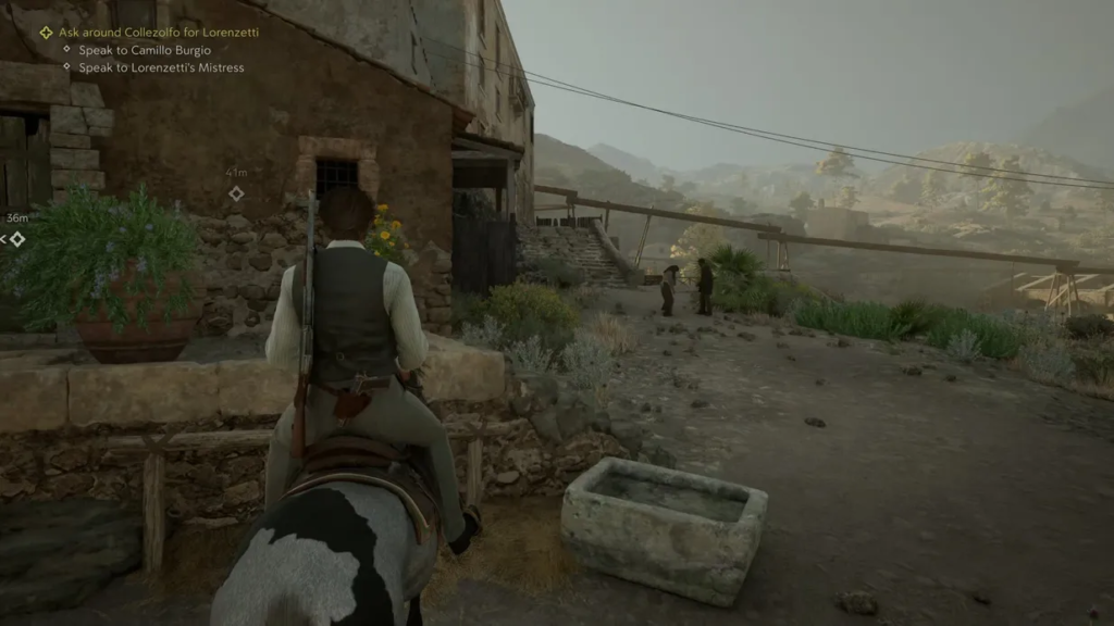 Rider on horse near stone house in village