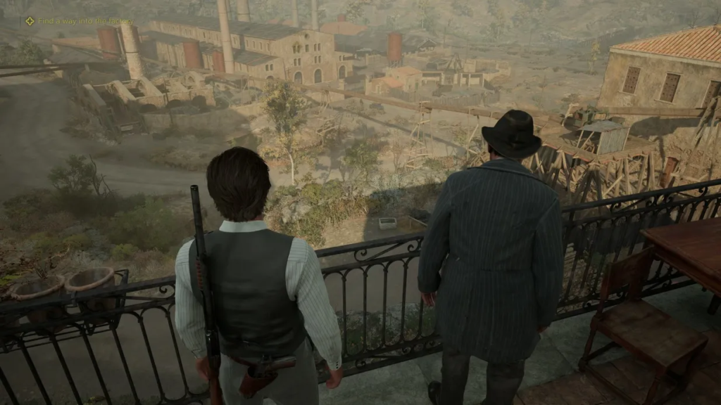 Two men overlooking factory complex from balcony railing