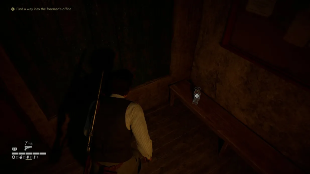 Player character loots key on wooden bench indoors