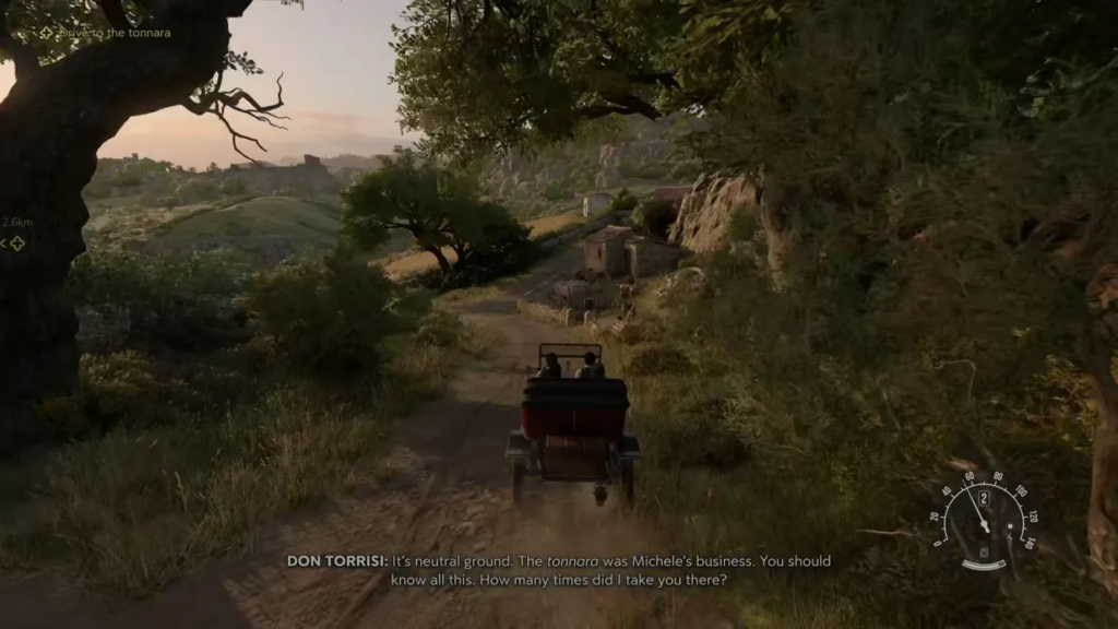 Car driving on dirt road through countryside hills