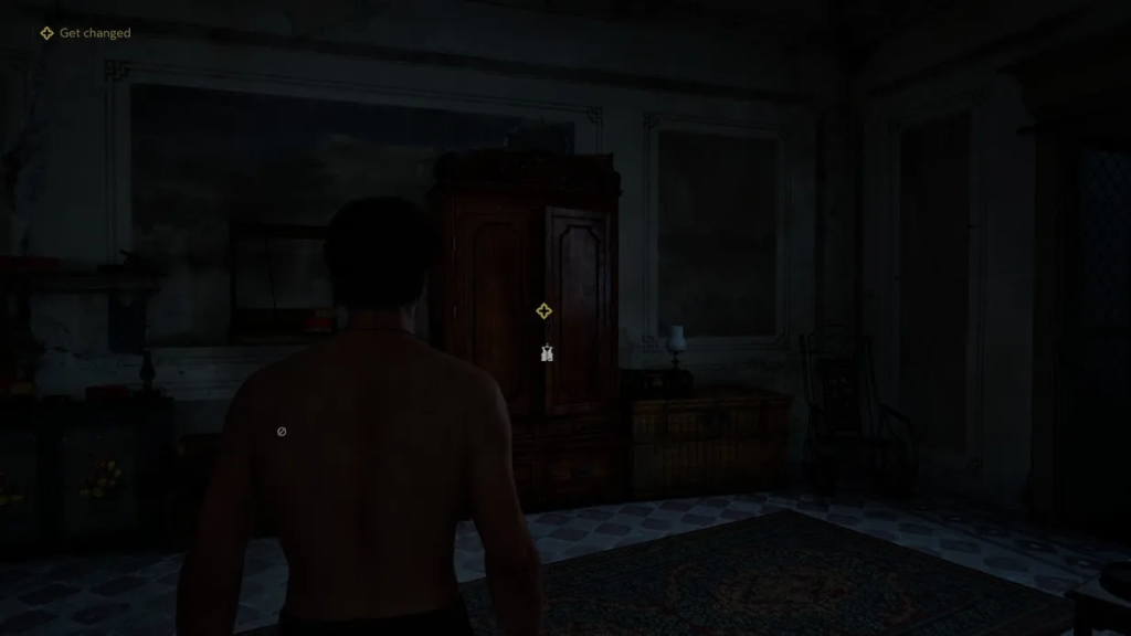 Shirtless man facing wardrobe in dark room