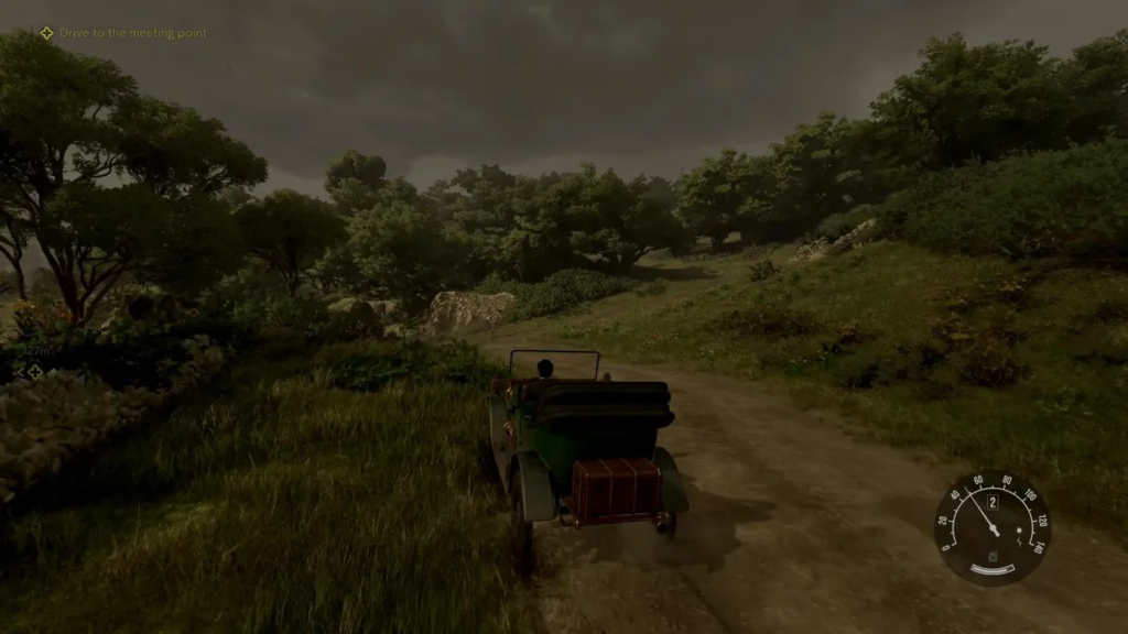 Car driving on dirt road through green hills