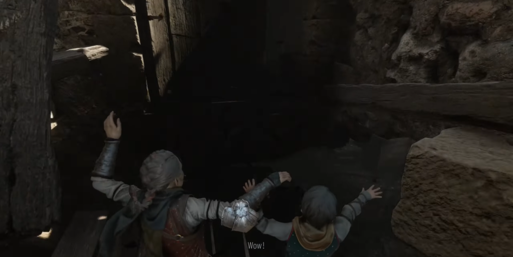 Two children climbing through wooden beams in cave