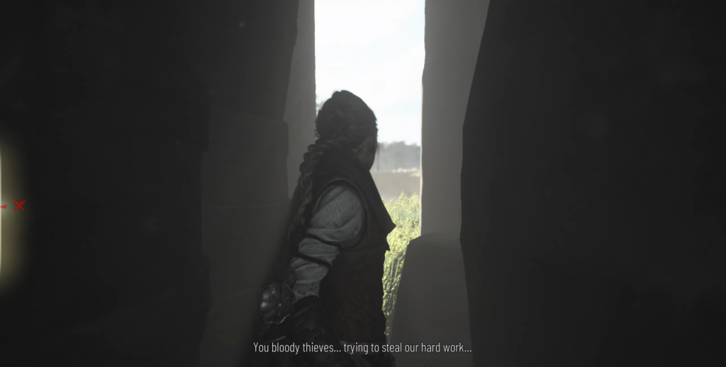 Woman with braided hair stands in doorway indoors