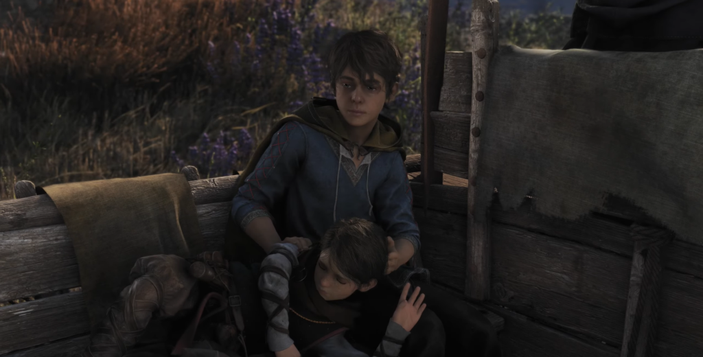 Hugo and Amicia sit in a wooden cart