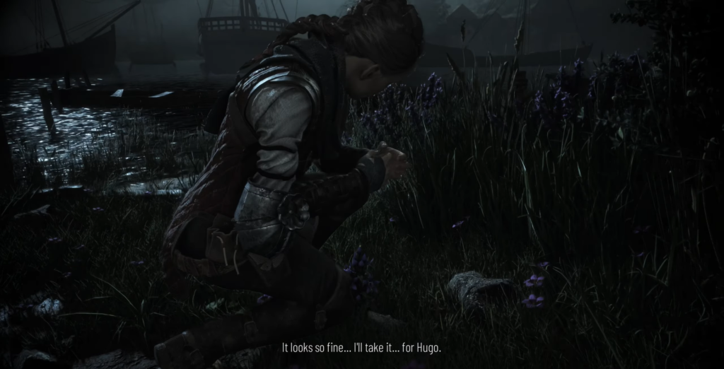 Amicia kneeling in grass near boats at night