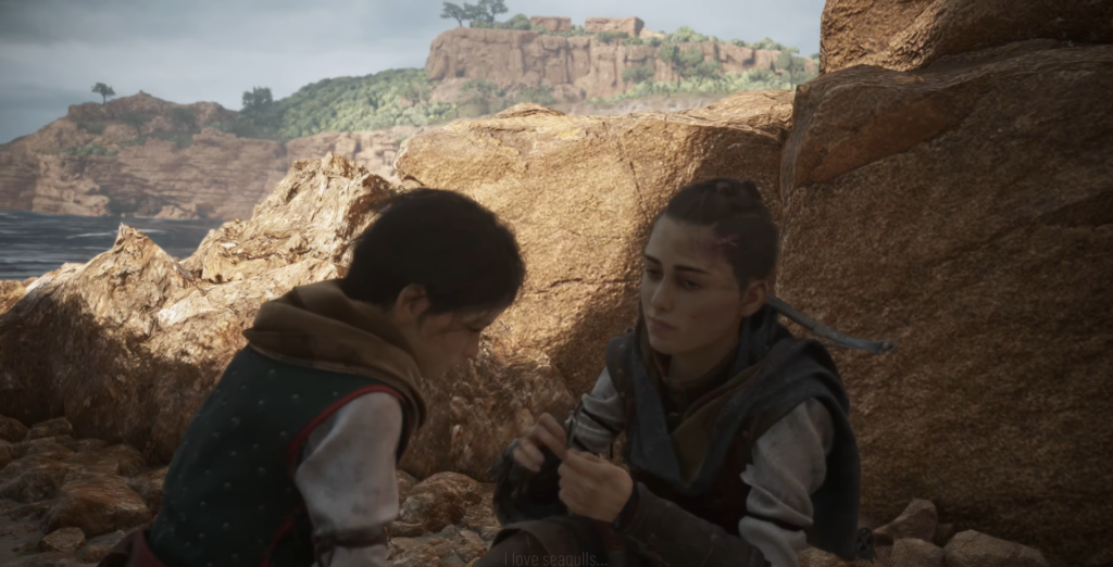 Amicia and Hugo sitting on rocky beach.