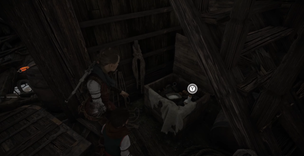 Amicia and Hugo inspecting items in wooden attic.