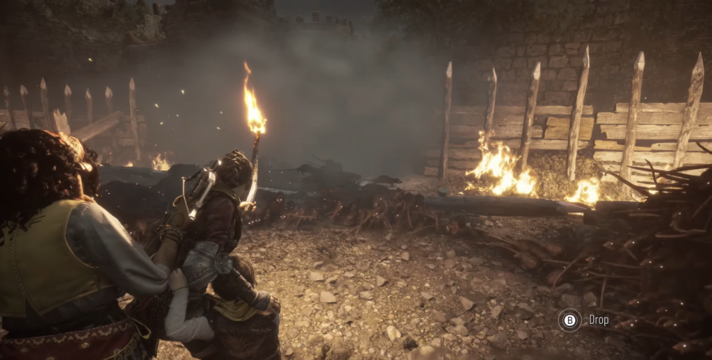 Hugo holds a torch near burning debris.